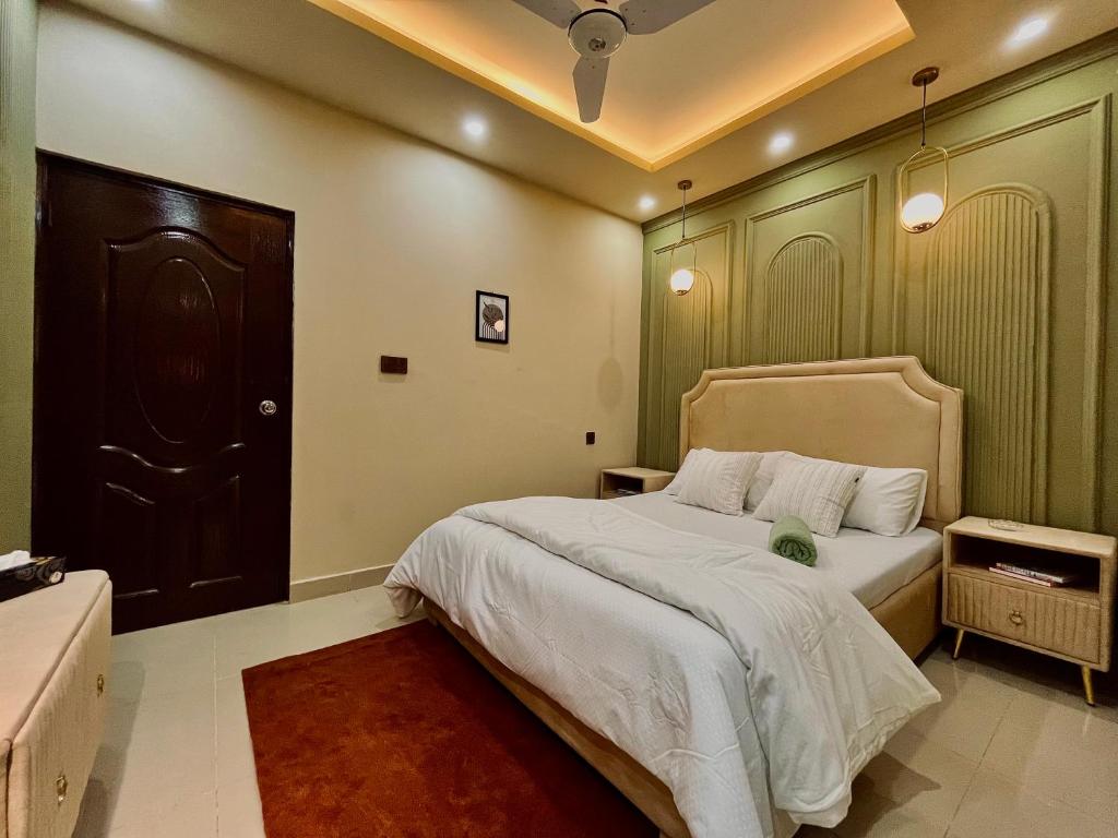 a bedroom with a large bed and a black door at 1-BHK Velvet Keys Executive Suite Near Clifton Beach in Karachi