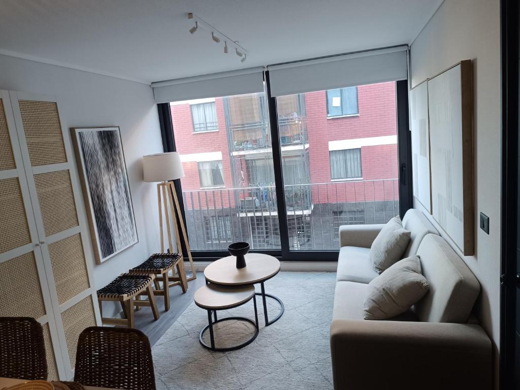 a living room with a couch and a table at Departamento Nuevo en Santiago Centro in Santiago