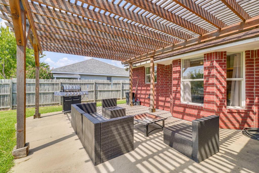 a patio with chairs and a table and a grill at Fenced-In Yard Family Home 4 Mi to Dtwn Killeen! in Killeen