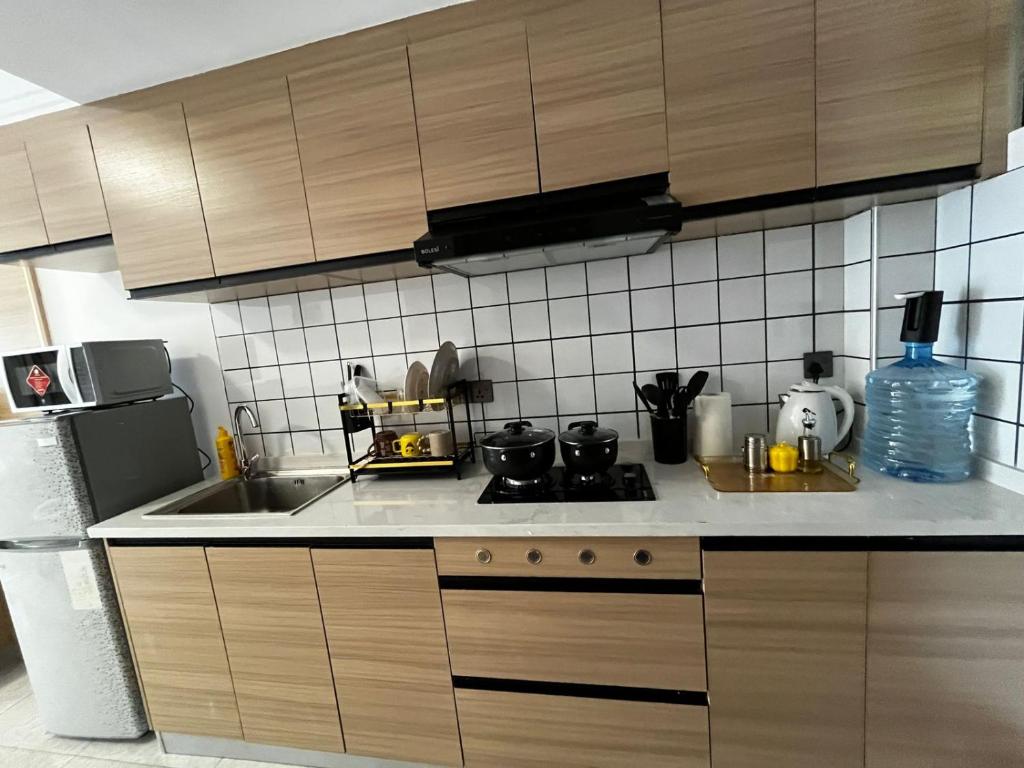 a kitchen with a sink and a stove top oven at Little Loft - The Loftel Ruaka in Nairobi