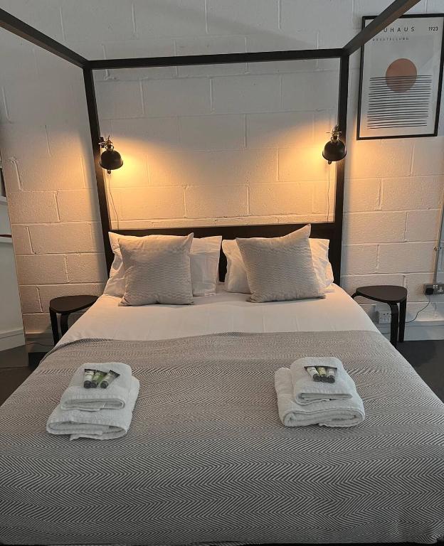 a bedroom with a bed with towels on it at Beautiful studio near the station in London