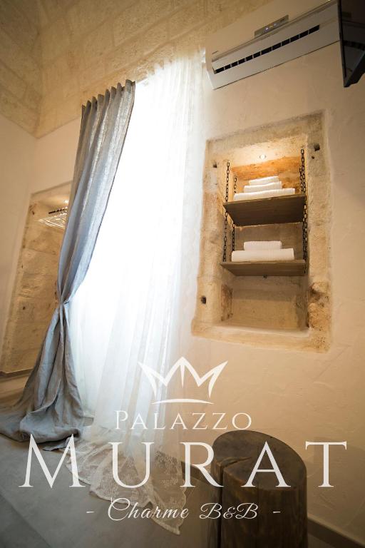 a window in a room with a curtain at Palazzo Murat B&B in Monopoli
