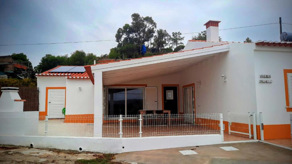 a white house with a fence in front of it at Sunny Aljezur da Misericórdia, Aljezur, Costa Vicentina in Aljezur