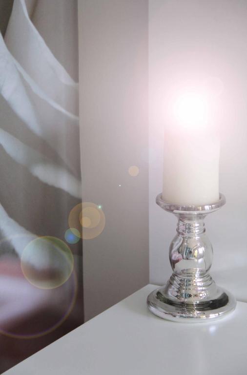 a candle in a glass holder on a table at Macedon in Limenas