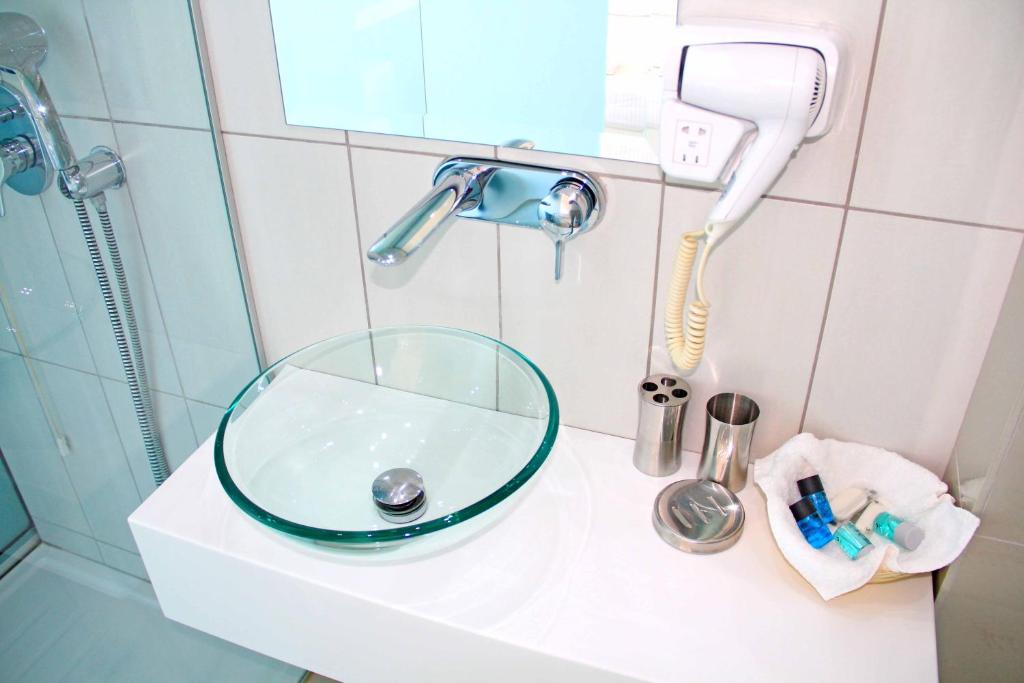 a bathroom sink with a glass bowl on it at Macedon in Limenas