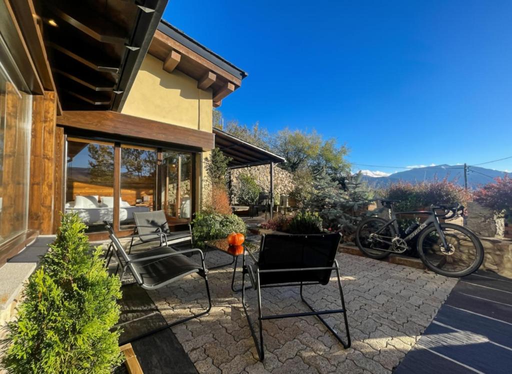 a patio of a house with chairs and bikes at Cal Gatesques 4 in Puigcerdà