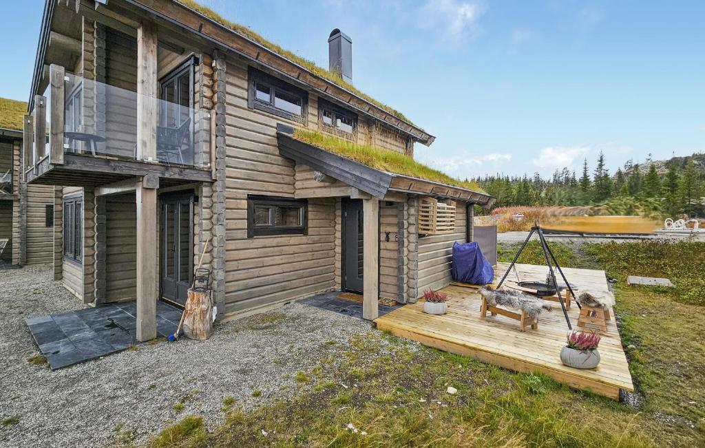 a log cabin with a porch and a swing at Nice Home In Gol With Sauna in Holtegard