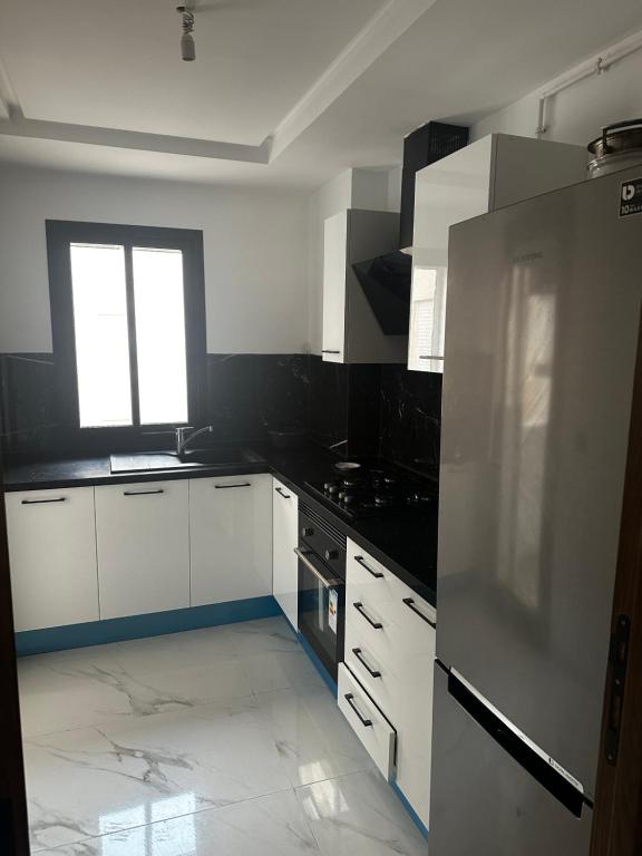 a kitchen with white appliances and a window in it at Palmier d'or in Tunis