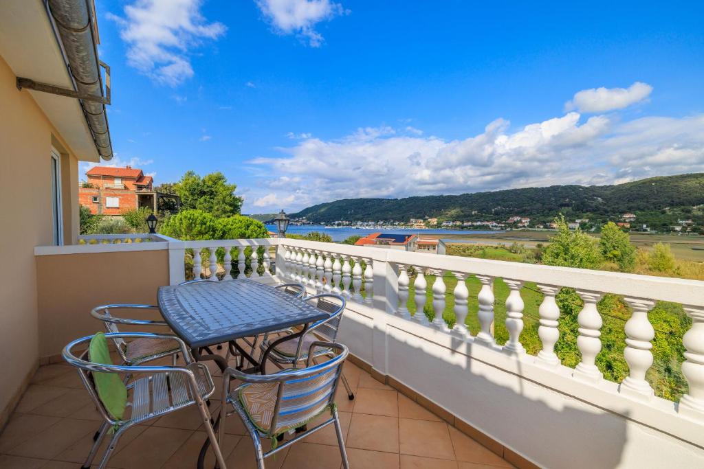 a balcony with a table and chairs and a view at Apartments Mig in Supetarska Draga