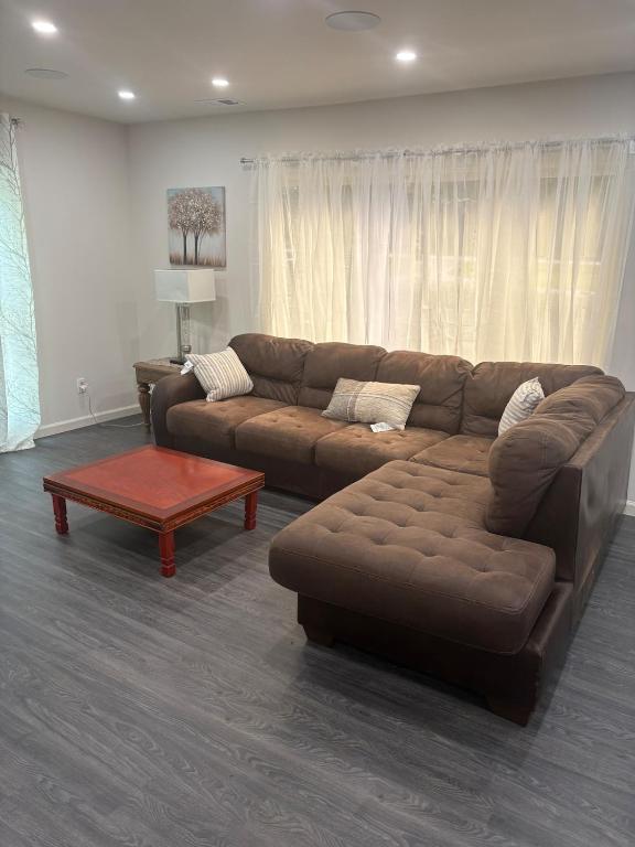 a living room with a brown couch and a coffee table at The Lofted Retreat in Newnan