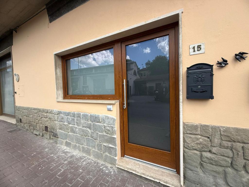 a wooden door on a building with a stone wall at Casa vacanze La Rondine in Stia