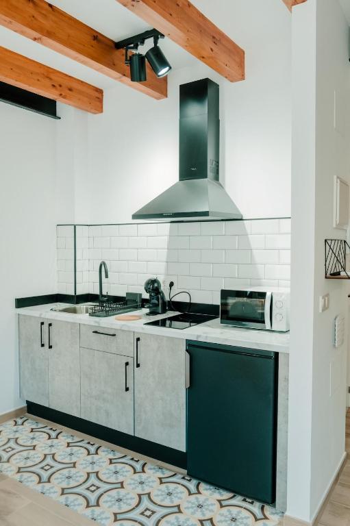 a kitchen with a sink and a stove at Romantic Boutique Apartment 2 in Villajoyosa