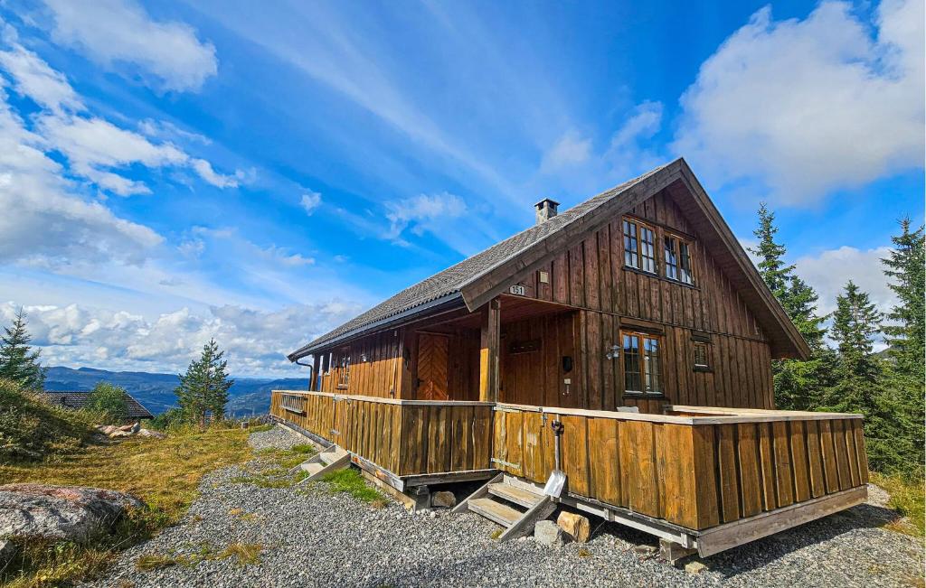 a large wooden house on a hill with trees at Awesome Home In Eggedal With Sauna in Eggedal