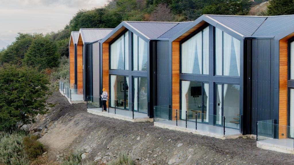 a row of glass homes on a hill at Studios del Susana - Dúplex Únicos y Exclusivos in Ushuaia
