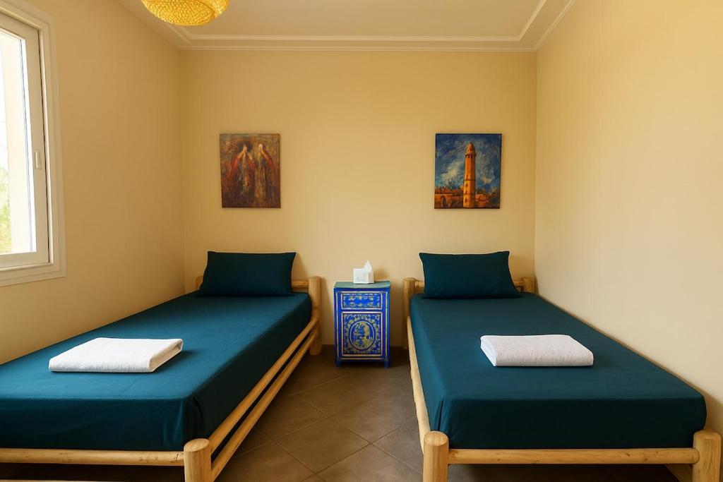 Una cama o camas en una habitación de Evasion au pied de l'Atlas - havre de paix avec jardin