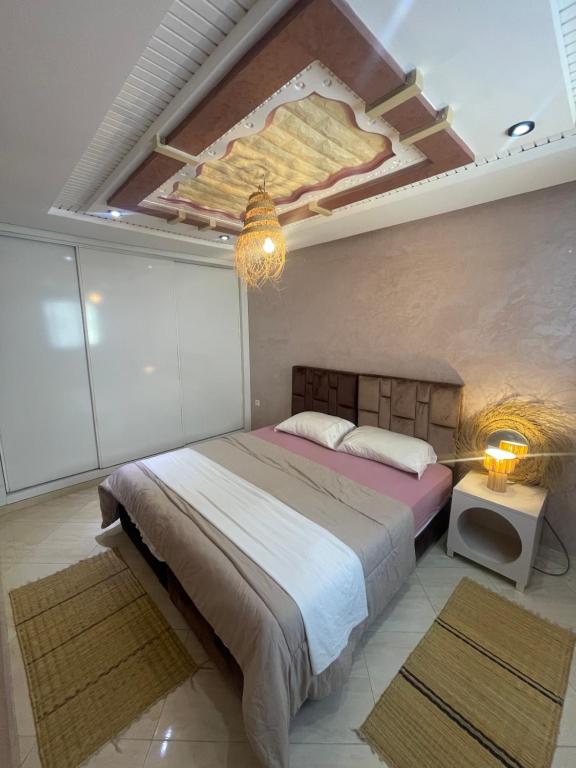 a bedroom with a bed with a painting on the ceiling at Papaya Hostel in Agadir