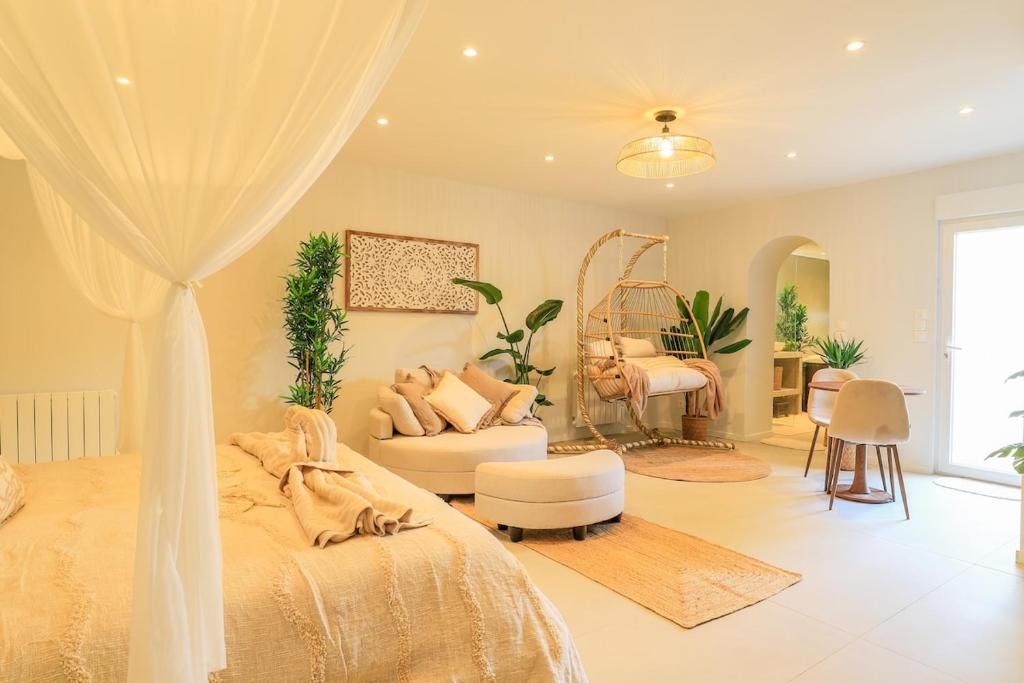 a bedroom with a bed and a couch and a mirror at Bali Lodge - Evasion balinaise - Jaccuzzi - Sauna in Lens