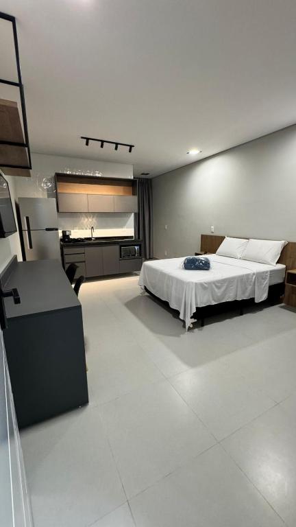 a large bedroom with a bed and a sink at Studios Gago 167 in Suzano