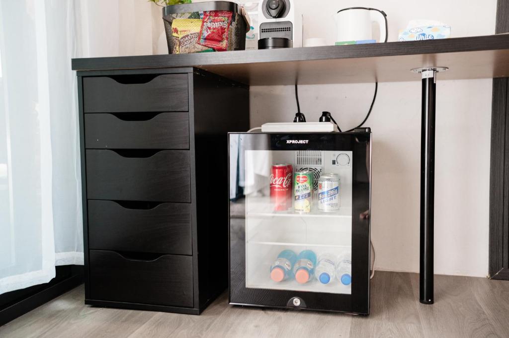 a small refrigerator under a desk with its door open at LasCalas Resort and Luxury Estate in Dasol