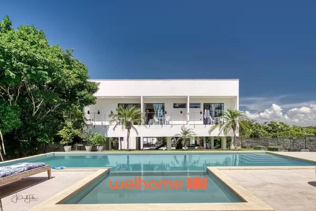 a villa with a swimming pool and a house at Suite em Tibau do Sul proximo as Dunas do Chapadao in Pipa