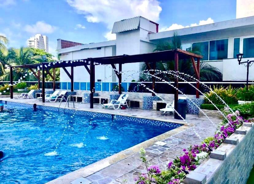 a swimming pool in front of a building at Hospedaje,Cartagena,Turismocolombia-fit in Cartagena de Indias
