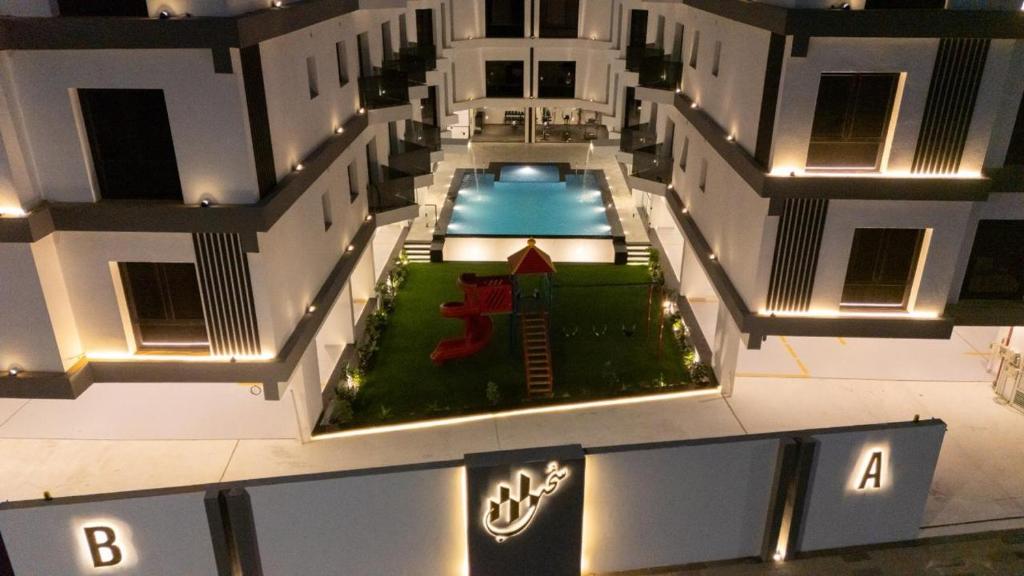 an aerial view of a building with a swimming pool at Sohob Compound in Al Khobar