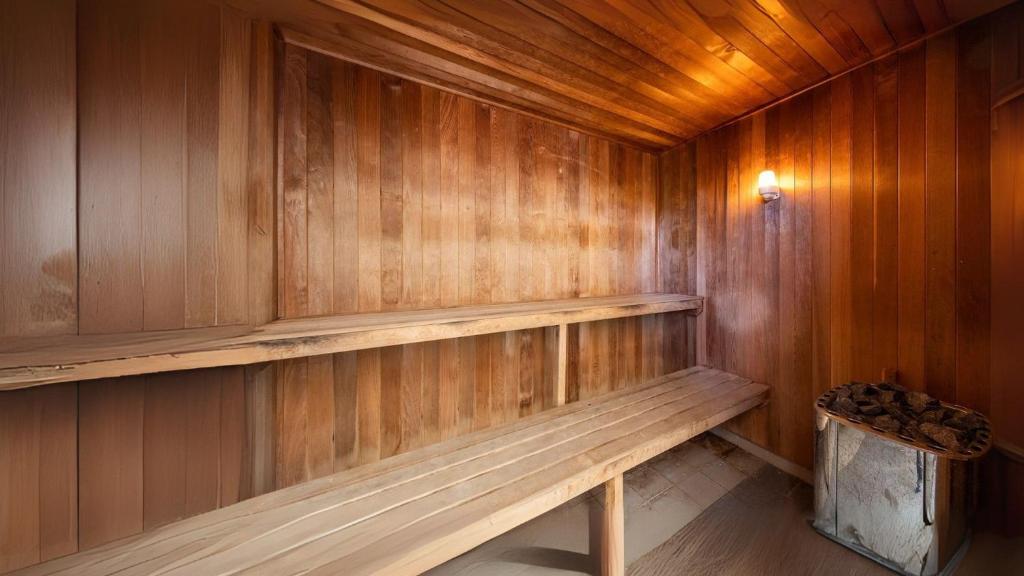 a sauna with wooden walls and a wooden bench at Absolute Beachfront in Broadwater