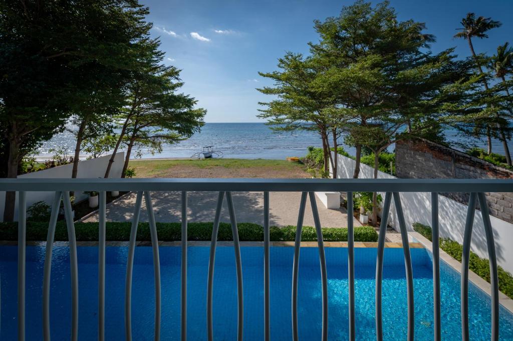 a balcony with a view of the ocean at Lusa Beach Studios Lovina in Lovina