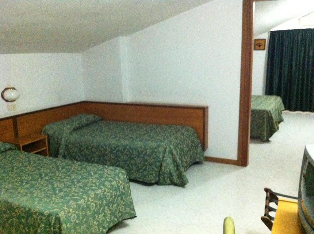 Postel nebo postele na pokoji v ubytování Hotel Atleti