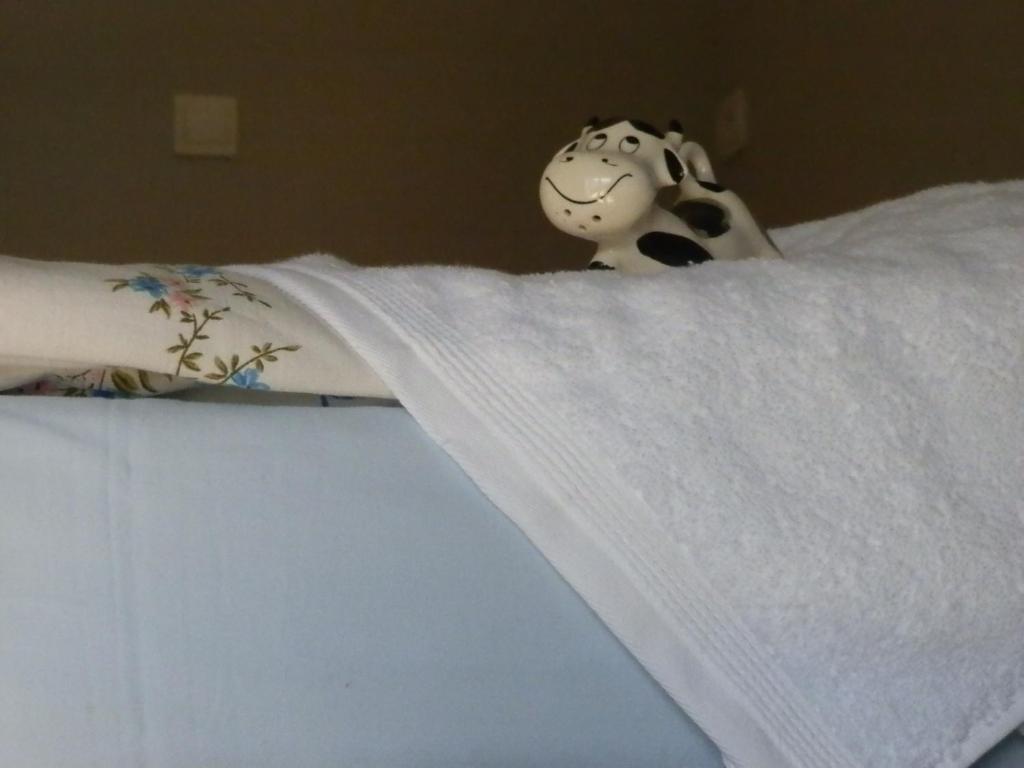 a stuffed cow is sitting on top of a bed at Studio Na Powiślu in Krakow
