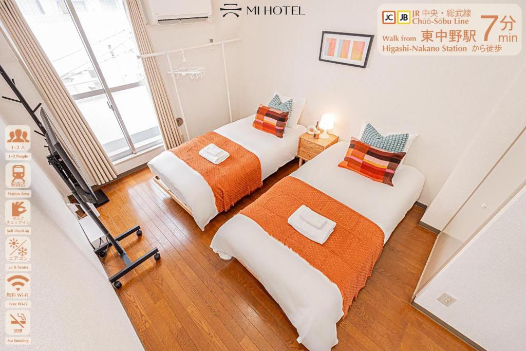 a room with two beds in a room at Shinjuku Wind Apartment • Cozy Retreats in Tokyo