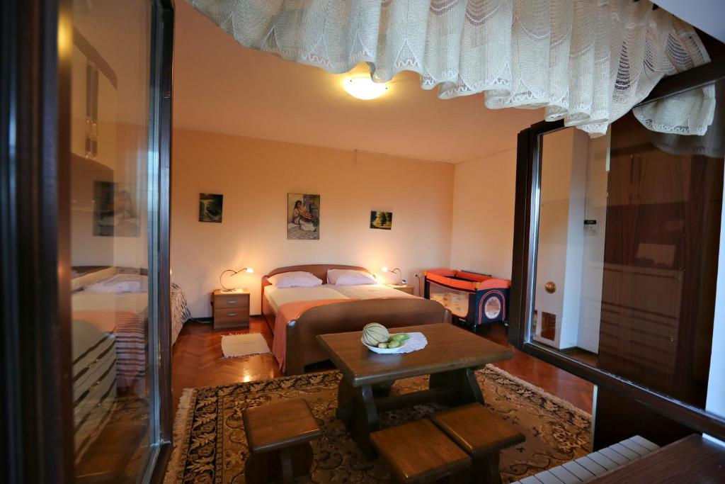a bedroom with a bed and a table in it at Villa Vera in Ičići