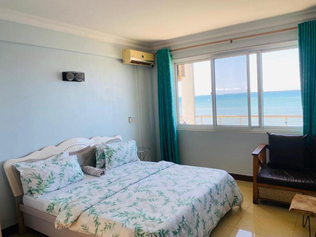 a bedroom with a bed with a view of the ocean at Hakuna Matata Ocean View Home - Msasani Near Masaki in Dar es Salaam