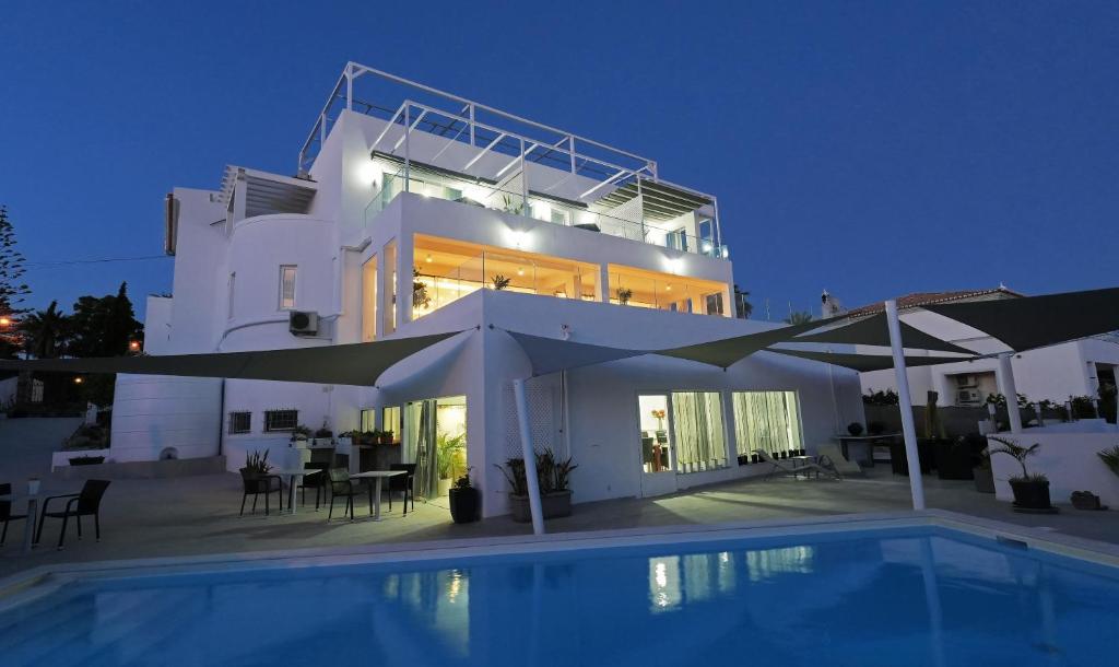 a villa with a swimming pool at night at Amigos para Sempre - Guesthouse in Ferragudo