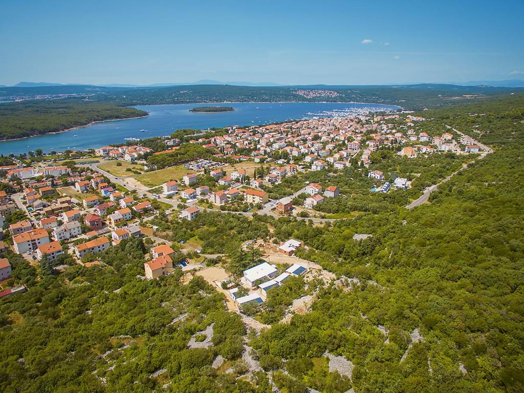 an aerial view of a town next to a river at Mobile Homes and Apartments St,Denis in Punat