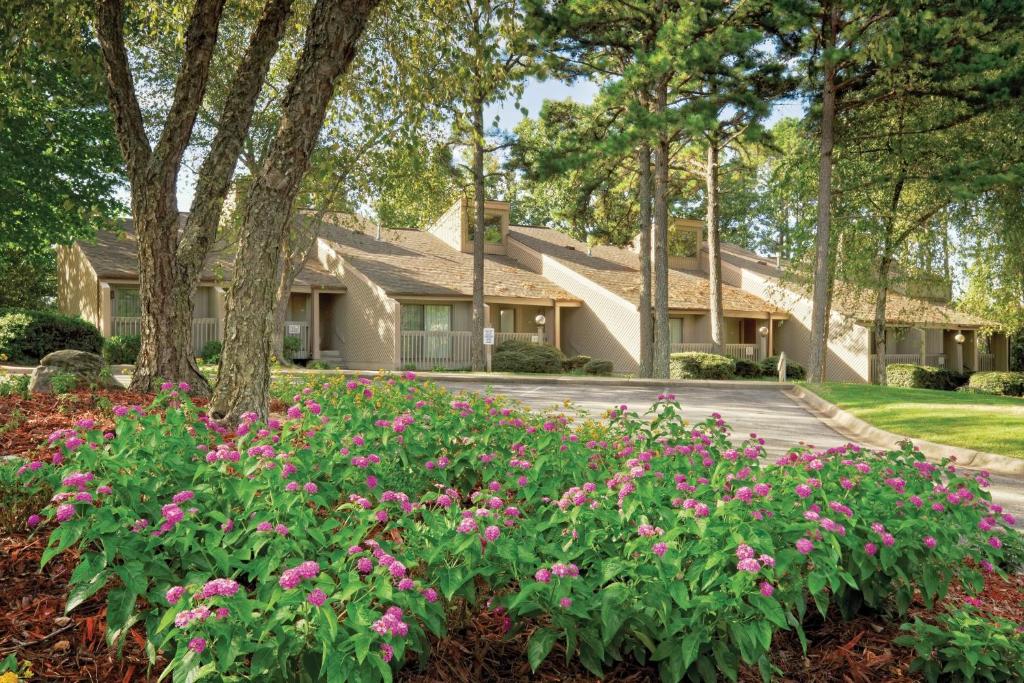 a house with pink flowers in the front yard at Club Wyndham Resort at Fairfield Bay in Fairfield Bay