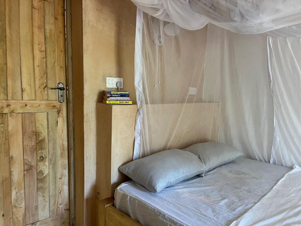 a bed in a room with a canopy at The Shamba in Kilifi