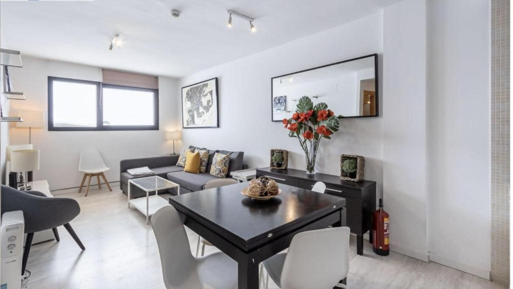 a living room with a couch and a table at Montegorbea Studio superior con parking privado incluido NEVADAHOME in Sierra Nevada