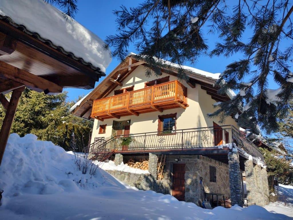 a house with a balcony in the snow at Wellness Vila Limaco Slovakia in Horné Jaseno
