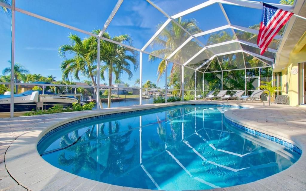 a swimming pool with an american flag in front of a building at Villa Viscaya in Shell Point Village
