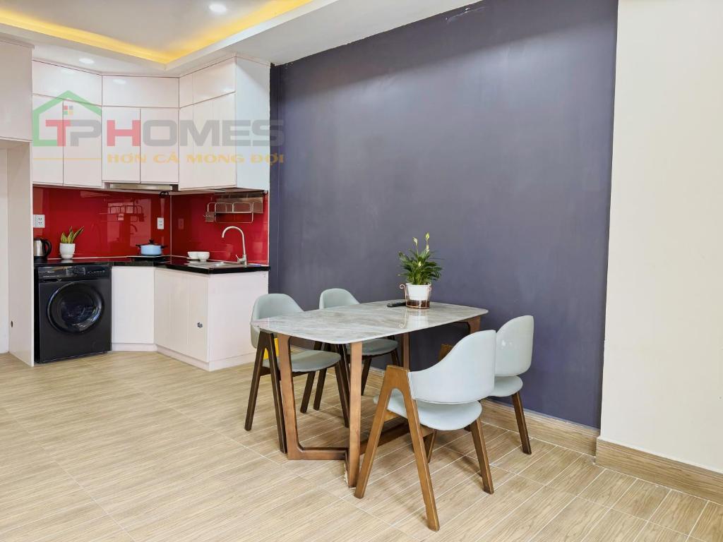 a kitchen and dining room with a table and chairs at TPHomes Mystery in Ho Chi Minh City
