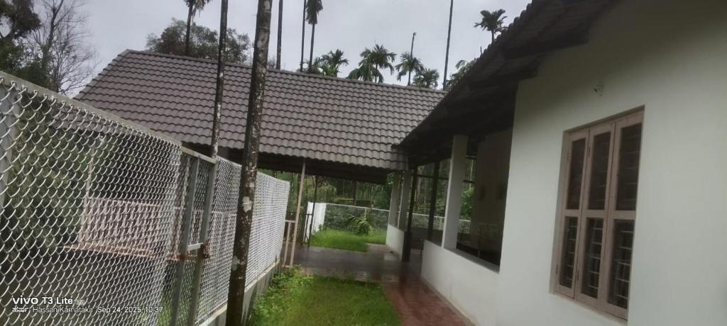 a white building with a fence and a gate at Thota'dha Tent Stay in SanivÄrsante
