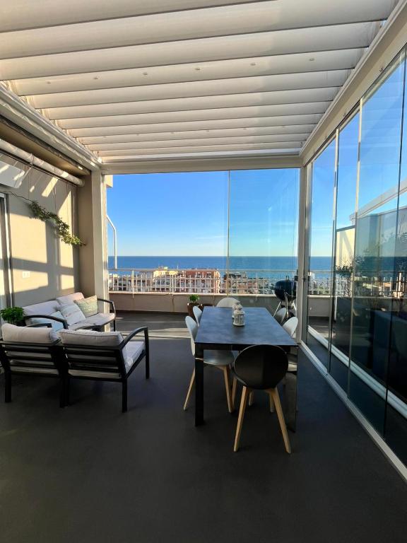 a living room with a table and a view of the city at Terrazza sul mare in Ladispoli