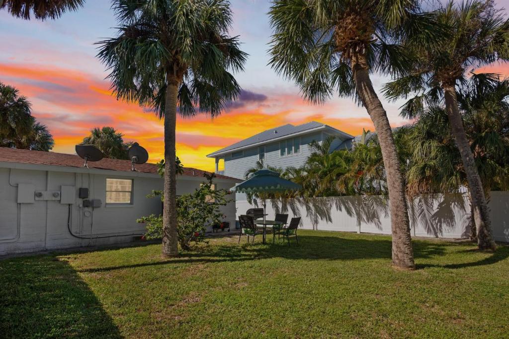 a house with palm trees in the yard at Gulf Haven in Anna Maria Island