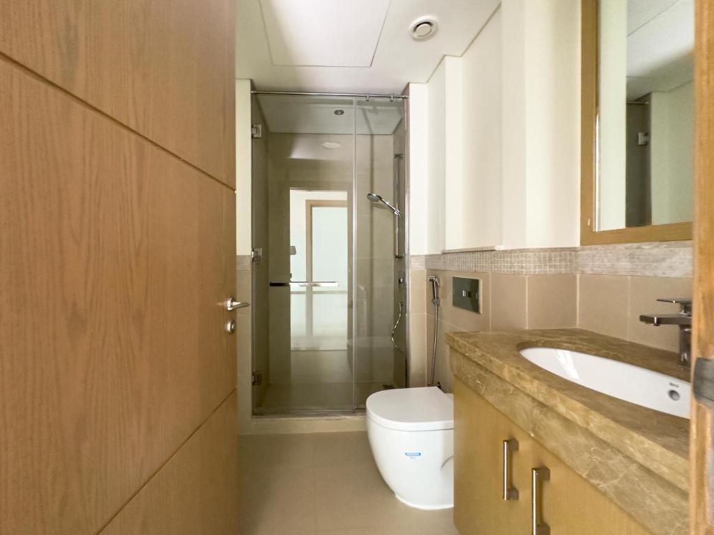 a bathroom with a sink and a toilet at Private Sea View Room in 3BR Downtown Apartment Direct Mall & Metro Access in Dubai