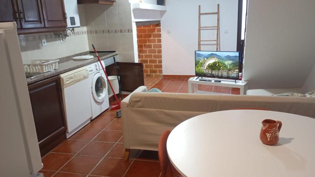 a living room with a couch and a table and a kitchen at Nisa 2 Bedrooms AC Villa in Monte Claro