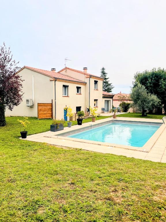 a house with a swimming pool in a yard at Le Petit Paradis Lescurien in Lescure-dʼAlbigeois
