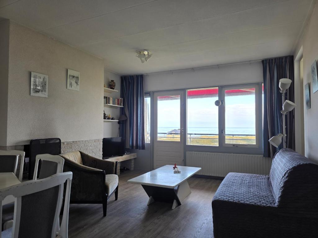 a living room with a couch and a table at Appartementencomplex Juliana 162 in De Koog