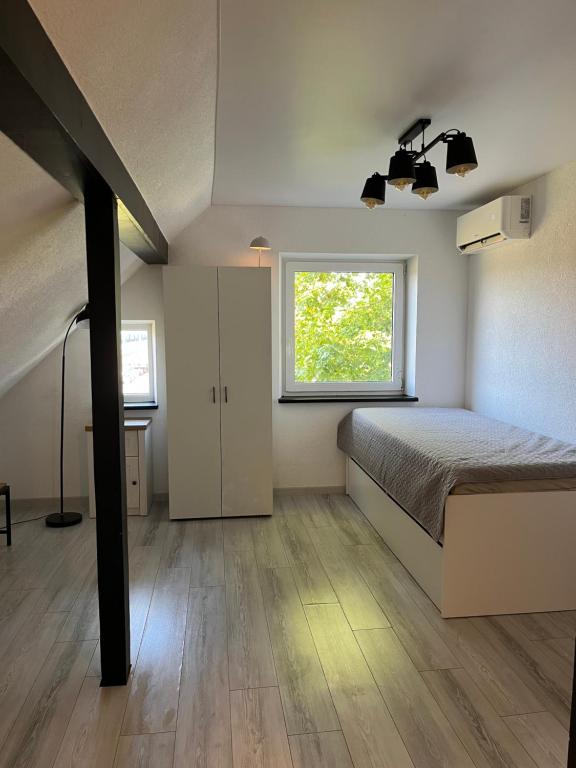 a bedroom with a bed and a window at Butas Pagėgiuose in Pagėgiai