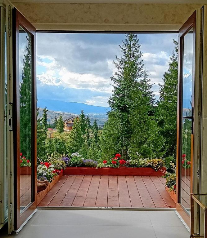an open door to a patio with a view at Harmony Retreat in Dealu Negru